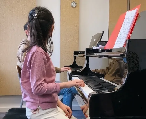 Child piano student during a lesson
