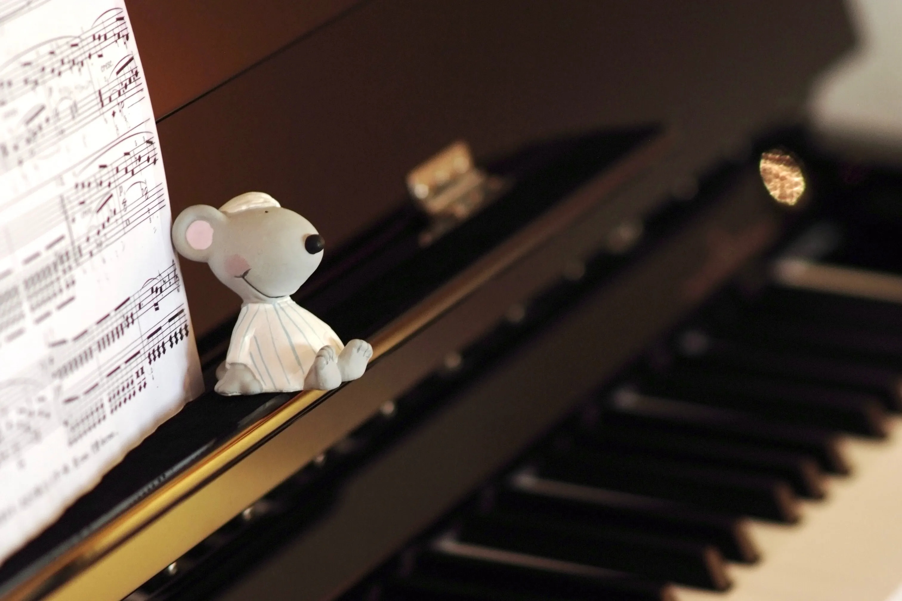 Piano, sheet music, and a small figure in a warm lesson atmosphere